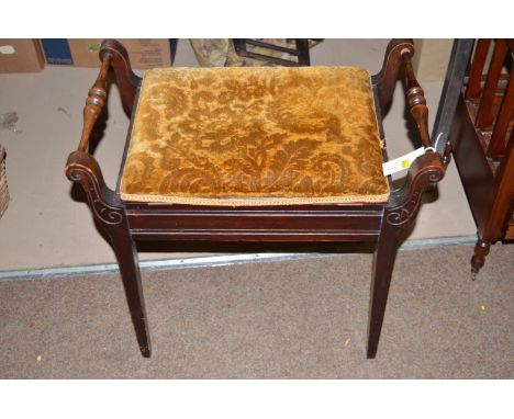 An early 20th Century stained mahogany piano stool with hinged seat.