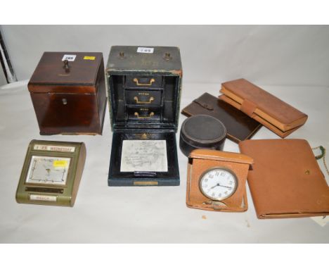 An early 19th Century mahogany tea caddy, inscribed 'BOHEA'; a Windsor eight-day travel clock; a leather travelling case by M