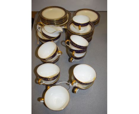 An Aynsley part tea service, to include: tea cups, saucers, cream jug, sugar, side plates and other items with cobalt blue bo