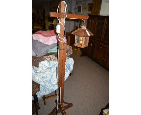 A 20th Century oak adjustable standard lamp in the form of a street lamp.
