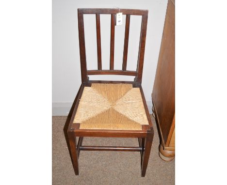 An Edward VII oak coronation chair with rushwork seat, stamped 'ERVII Coronation' to back of seat.