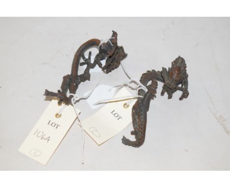 A pair of 20th Century Chinese bronze dragon ornaments.