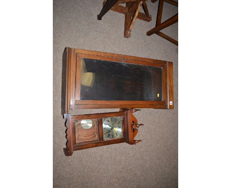 A modern wall clock; together with a glazed wooden case.