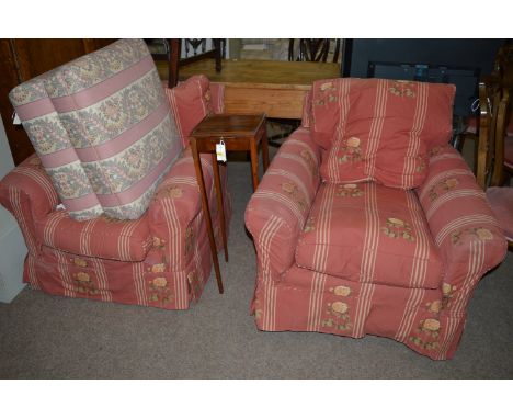 A pair of upholstered easy armchairs with long seats and turned wooden feet; together with an early 20th Century pouffe uphol