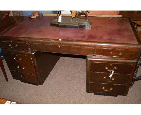 An Art Deco stained wood pedestal desk, fitted various drawers and opposing cupboard doors, 163 x 87 x 77cm high.
