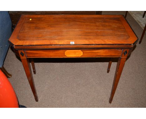 An early 19th Century mahogany turnover top card table canted rectangular, with satinwood and ebony crossbanding and stringin