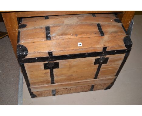 A stripped wood black painted metal-bound dome topped chest trunk, 75cms wide.