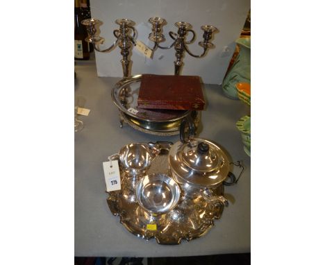 Plated metalware, to include: a pair of candelabra; a three-piece tea service; and other items.