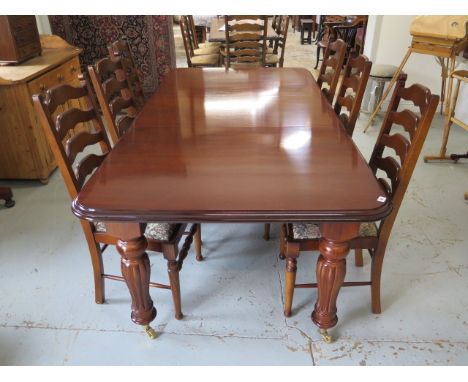 A mahogany effect 19th century style pullout dining table with one leaf and six ladder back dining chairs, table 76cm tall, 1