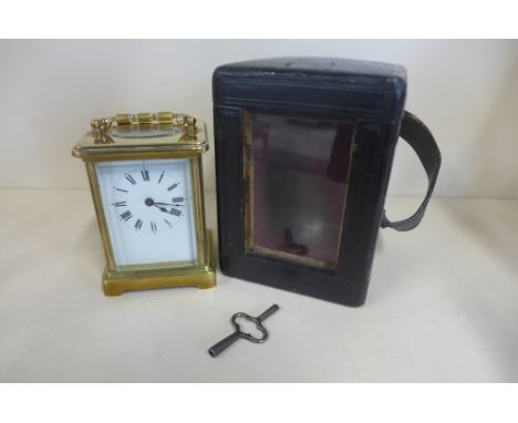 An 8 day carriage clock with case - 12cm tall, with key and running but stops 