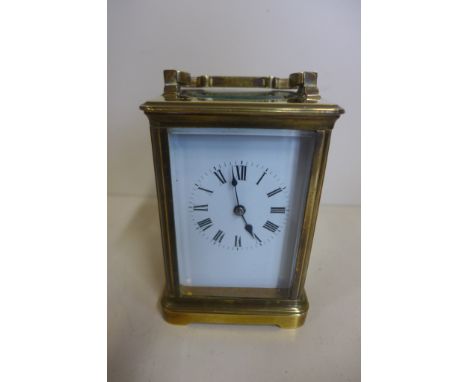 An 8 day brass carriage clock, 14cm tall, with key, running, generally good 