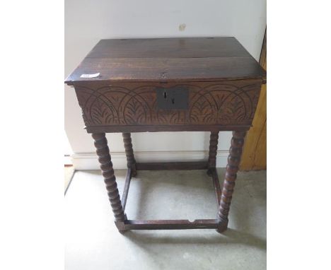 A late 17th/early 18th century oak bible box, with later stand, incorporating bobbin turned legs, some restoration required, 
