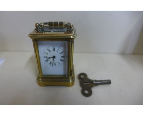 An 8 day miniature carriage clock, 8cm tall, running 