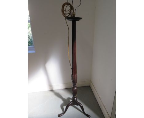 A Georgian mahogany standard lamp with shaped and reeded column, enhanced with carved wheat ears, replacement flex and brass 