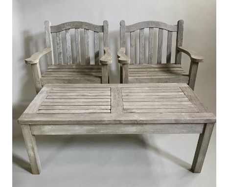 GARDEN ARMCHAIRS AND TABLE, a pair, substantial silvery weathered teak with flat top arms, and shaped rails by 'Teak Tiger Tr