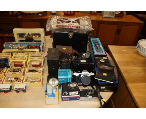 A quantity of various cameras and lenses to include boxed Polaroid, Praktica, Olympus, Hanimax lens etc.