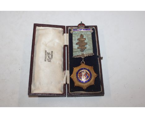 A 9ct gold enamel decorated Masonic medal, approx. 33gms and a ribbon and silver Roll Of Honour bar and pin 