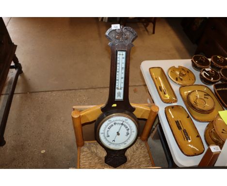 A carved oak cased banjo barometer / thermometer