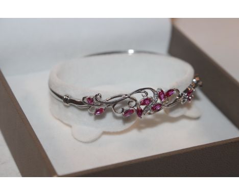 A Sterling silver diamond and tourmaline bangle 