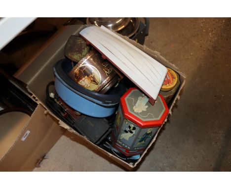 A box containing various tins, model boat etc.