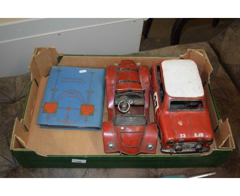 Two metal models of vintage cars together with an album of cigarette cards