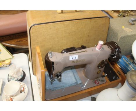 An electric Singer sewing machine with fitted case sold as collectors item