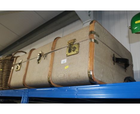 A wooden and metal bound travelling trunk