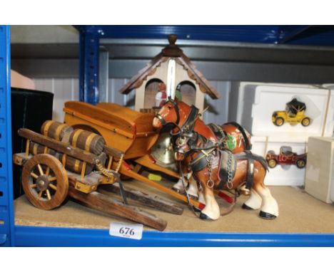 A barometer and two horse and cart ornaments 