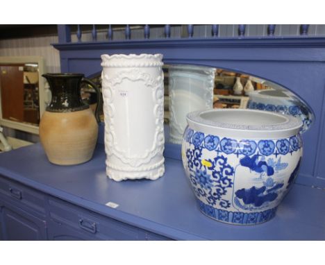 An Oriental blue and white vase, a white glazed stick stand and a green glazed jug  