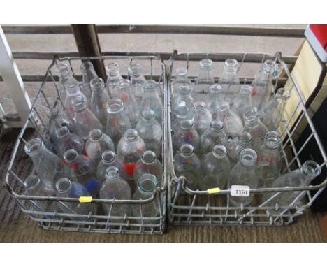 Two wire baskets and contents of vintage milk bottles