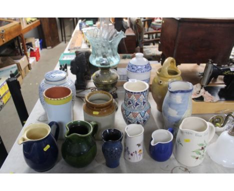 A quantity of jugs, pasta storage jar, a brass oil lamp converted to electricity, ginger jar and cover