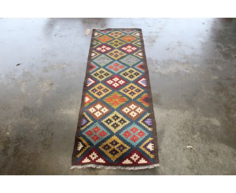 An approx 6'6" x 2'2" Chobe Kilim runner