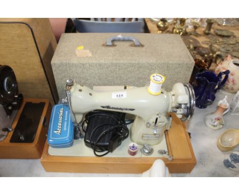 A Gamages electric sewing machine in fitted case, sold as collectors item