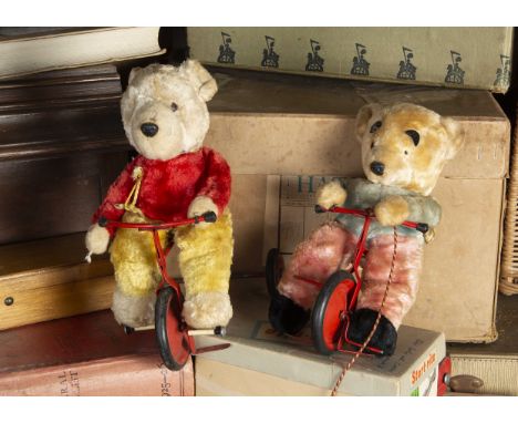 Two post-war Chiltern Teddy Bears on tricycles, Cookson, with white, red and yellow artificial silk plush and red painted tri