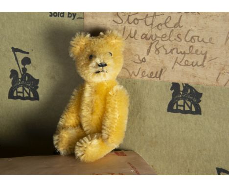 A post-war Schuco miniature Teddy Bear, with light golden mohair, black metal pin eyes, black stitched nose and mouth and met