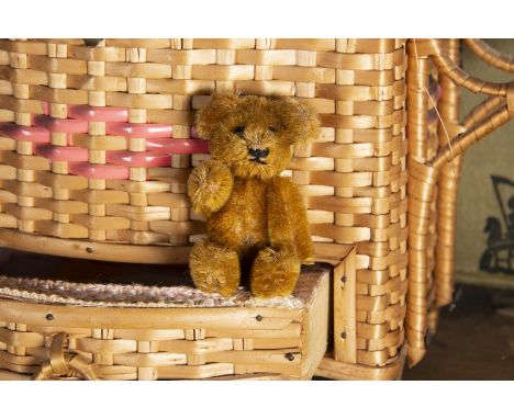 A post-war Schuco miniature Teddy Bear, with light brown mohair, black pin eyes, black stitched nose and mouth and metal fram