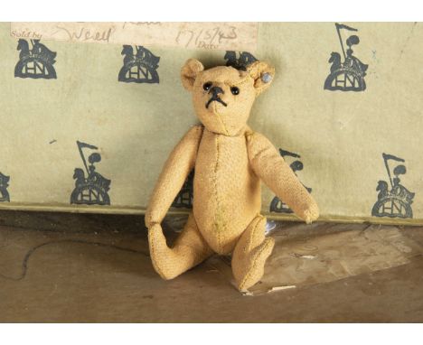 An early small Steiff Teddy Bear circa 1910, with remnants of golden mohair, black boot button eyes, pronounced muzzle, black