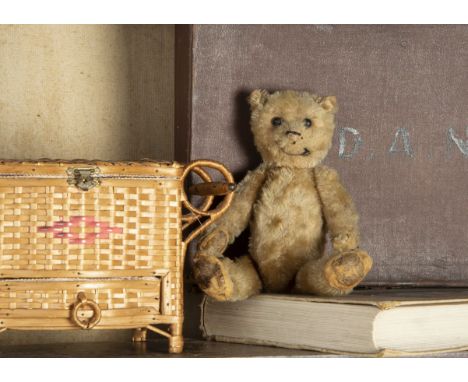 A small German Teddy Bear 1920s, with dark blonde mohair, black boot button eyes, pronounced muzzle, remains of black stitche