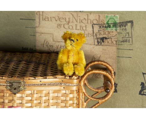 A post-war Schuco miniature Teddy Bear, with bright golden mohair, black pin eyes, black stitched nose and mouth and metal fr