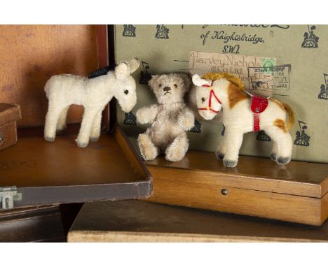 A small post-war Steiff Teddy Bear and friends, with beige mohair, brown and black glass eyes, pronounced muzzle, brown stitc