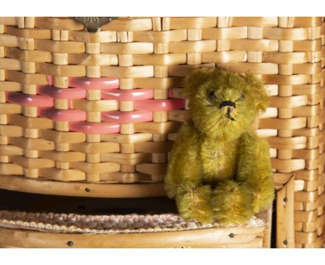 A post-war Schuco miniature Teddy Bear, with old golden mohair, black pin eyes, black stitched nose and mouth and metal frame