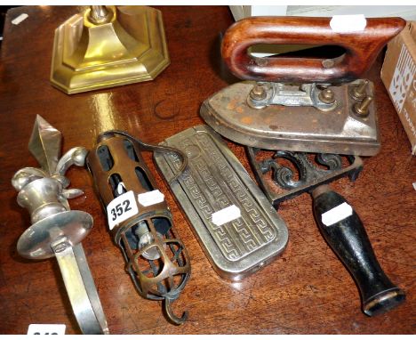 Vintage copper car inspection lamp, a wall sconce, Rolls razor, and an early electric iron on a trivet