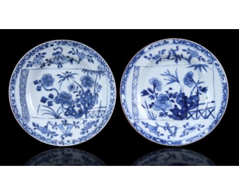 2 porcelain dishes with blue and white floral decor, including parchment scroll, China Kangxi period, 22.5 cm diameter (edge 
