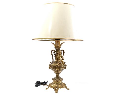 Classic brass richly decorated table lamp with putto, ears and plastic shade, 73 cm high