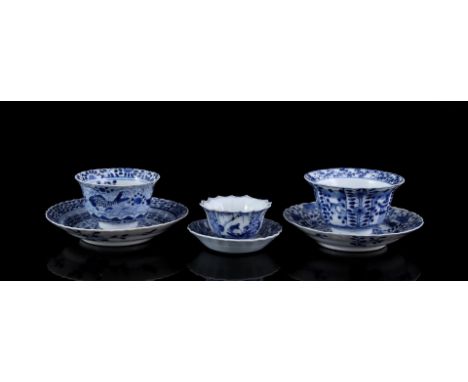 3 porcelain cups and saucers with different blue and white decor, Kangxi marked, China 18th and 19th century