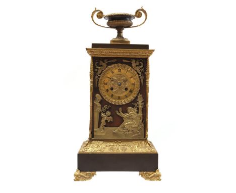 Brass Louis Seize&nbsp;table clock with vase on top, classic representation on front and standing on dolphin legs, 52 cm high