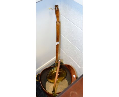 A copper helmet shaped coal bucket, swing handle;  a brass warming pan (2)