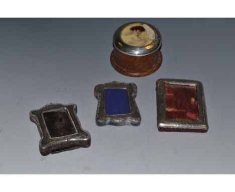 A late Victorian miniature silver photograph frame, Birmingham 1899; another similar, later, Birmingham 1909; a George V silv