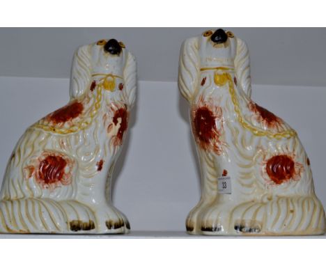 A pair of Victorian Staffordshire spaniels, seated to the left and right, brown patch markings, c.1880