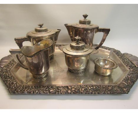 A Spanish silver six piece tea service comprising a two handled tray, teapot, water jug, milk jug, sucrier and two strainer w